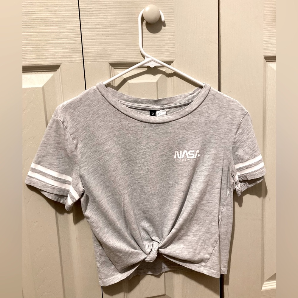 The shirt is a crop top. It’s easy to style. You simply tie the two strings.